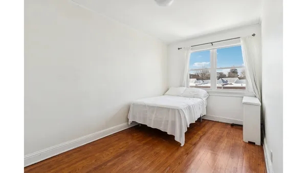 a kitchen with stainless steel appliances granite countertop a stove a refrigerator a dining table and chairs with wooden floor