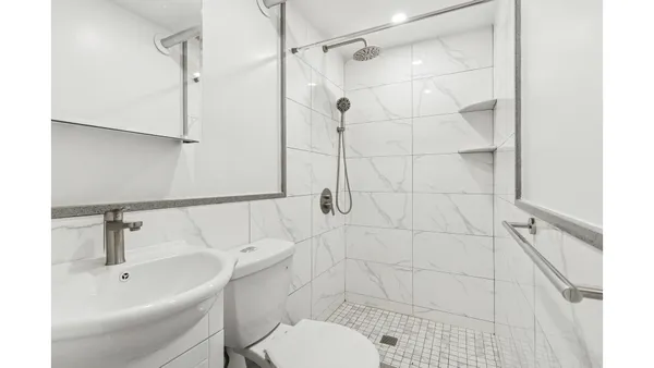 a bathroom with a sink toilet and shower