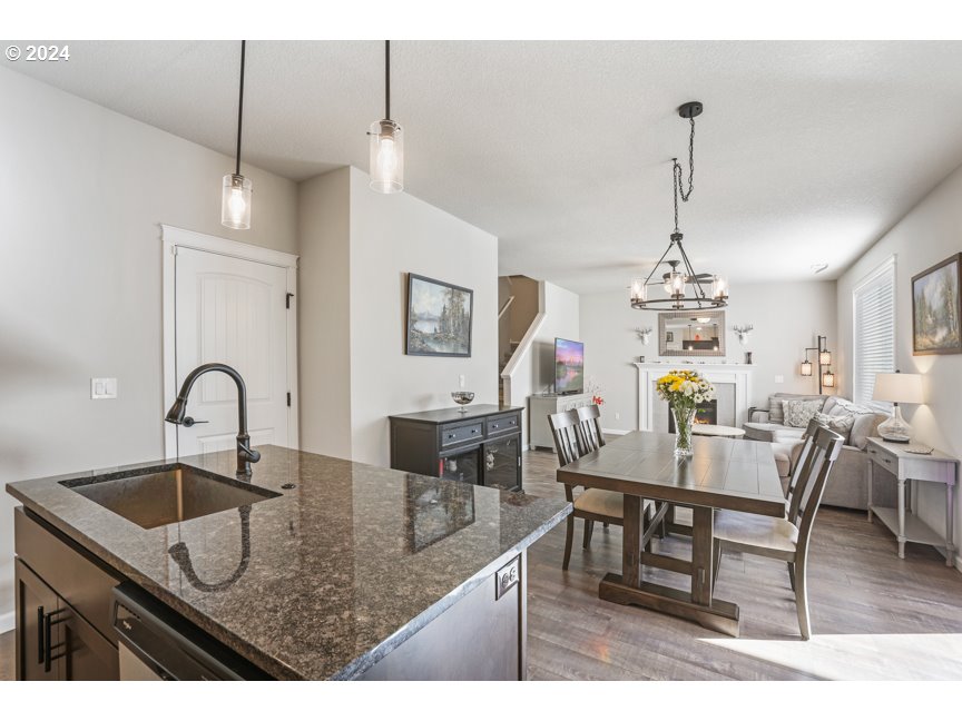 59551 Emerald Loop St. Helens, OR 97051 - Photo 25 of 40 a kitchen with kitchen island granite countertop a table and chairs in it