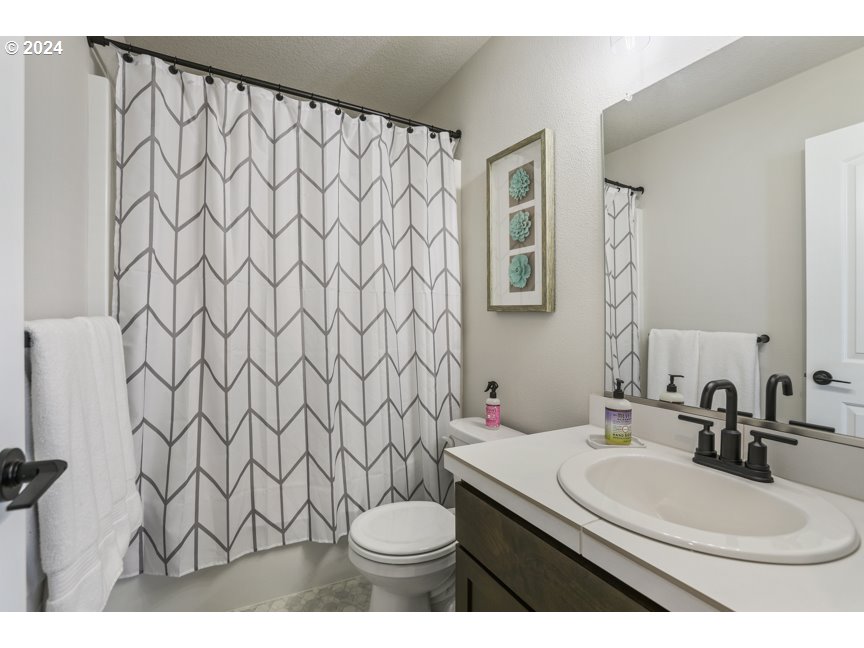 59551 Emerald Loop St. Helens, OR 97051 - Photo 35 of 40 a bathroom with a sink a toilet and a mirror