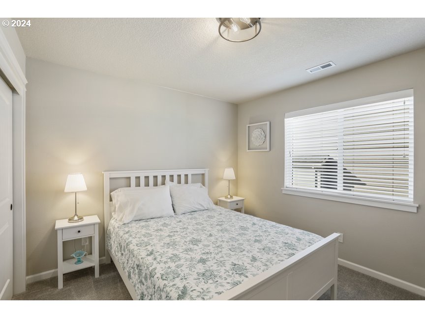59551 Emerald Loop St. Helens, OR 97051 - Photo 36 of 40 a bedroom with a bed and a window