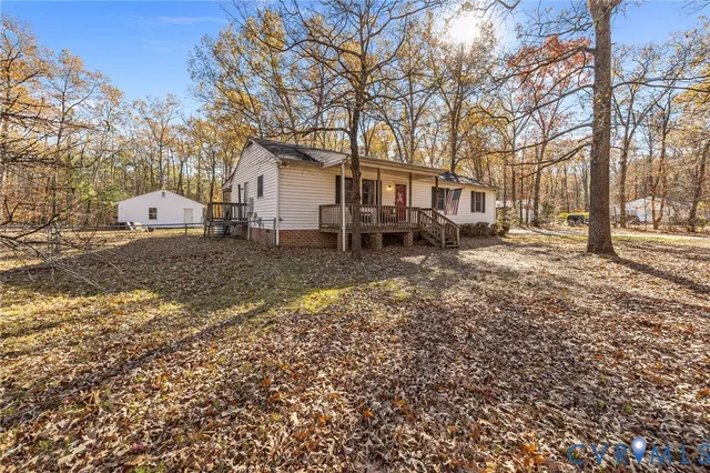 a backyard of a house with barbeque oven table and chairs