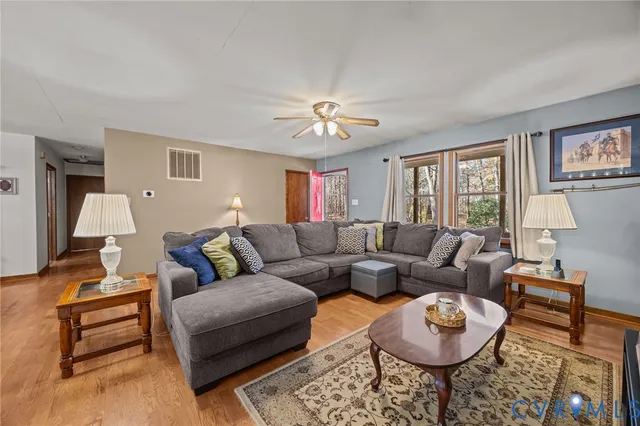 a living room with furniture a rug and a chandelier