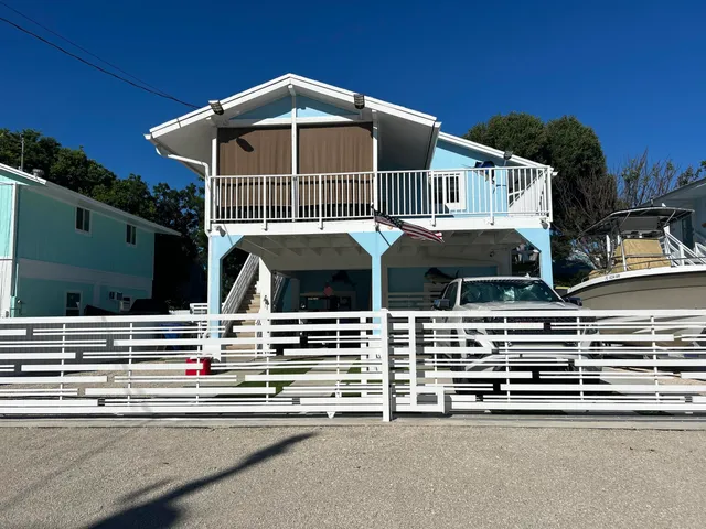 a roof deck with table and chairs under an umbrella
