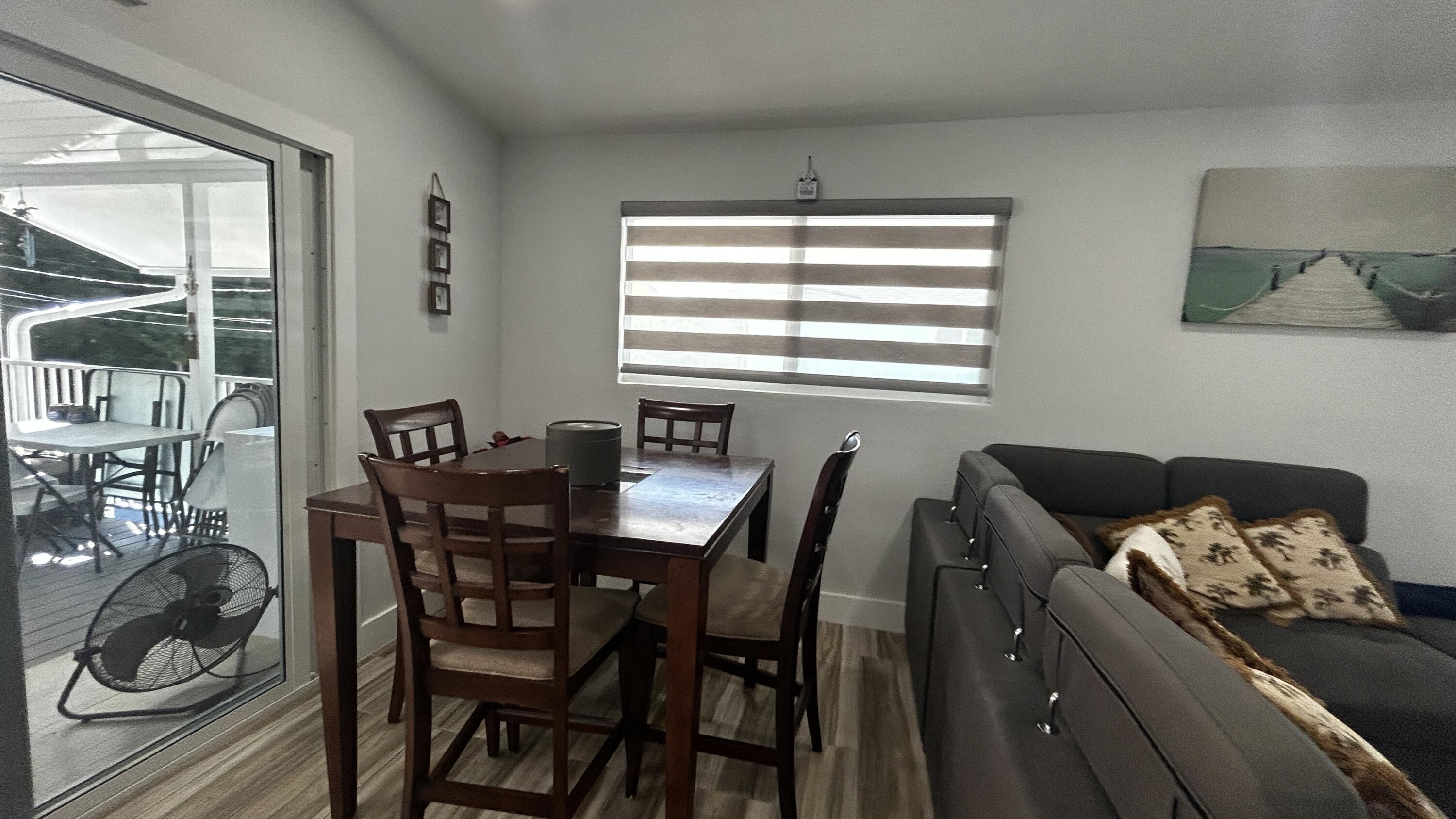 423 Mahogany Avenue Key Largo, FL 33037 - Photo 16 of 37 a view of a dining room with furniture and window