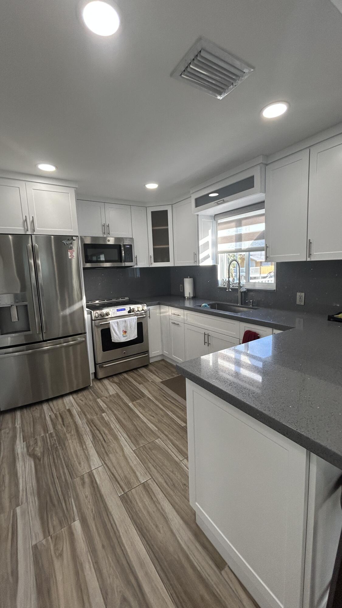 423 Mahogany Avenue Key Largo, FL 33037 - Photo 29 of 37 a kitchen with stainless steel appliances granite countertop a sink a stove and a refrigerator