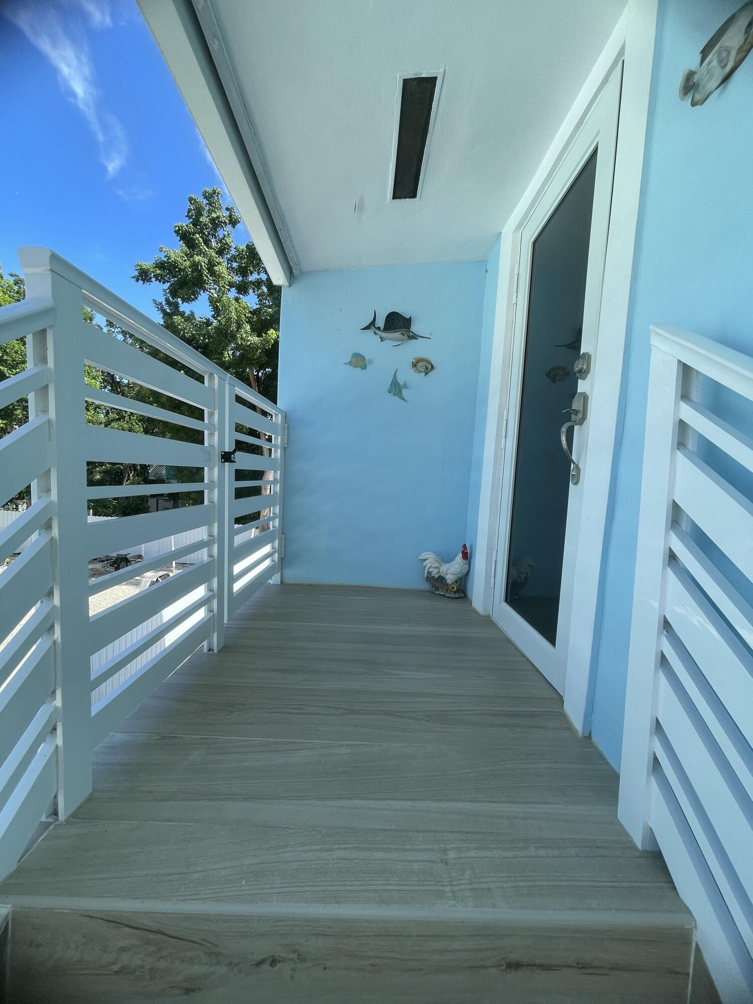 423 Mahogany Avenue Key Largo, FL 33037 - Photo 4 of 37 a view of wooden floor and windows in a room