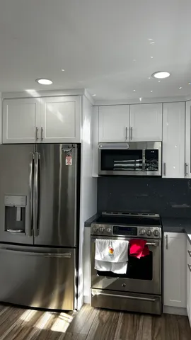 a view of kitchen and living room with a flat screen tv