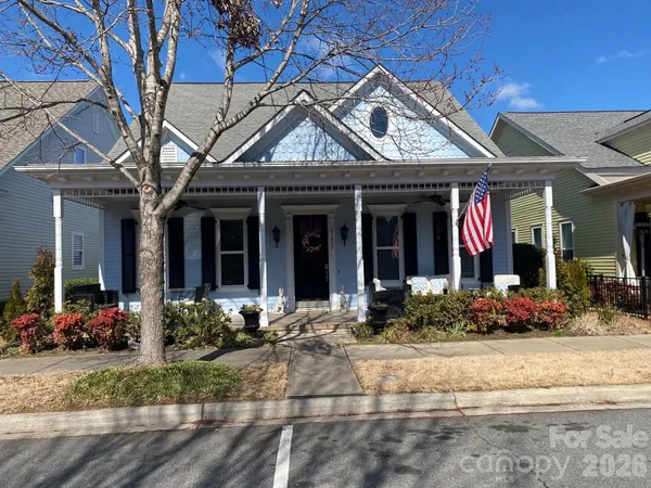 front view of a brick house with a small yard