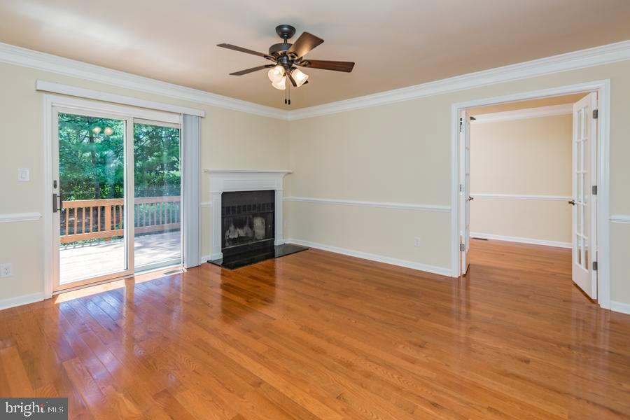 20 Exeter Court Princeton, NJ 08540 - Photo 8 of 25 an empty room with wooden floor fireplace and windows
