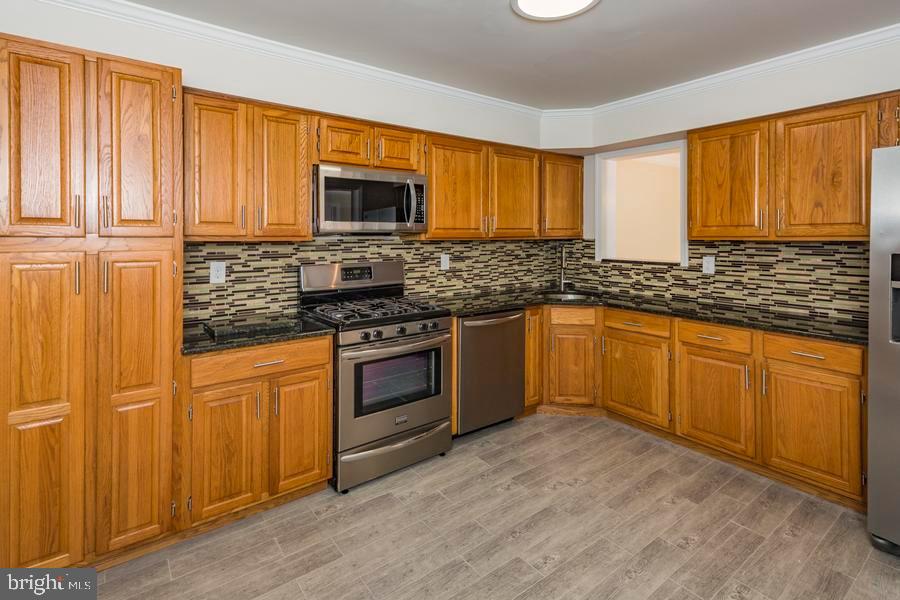 20 Exeter Court Princeton, NJ 08540 - Photo 10 of 25 a kitchen with stainless steel appliances granite countertop a stove sink and microwave