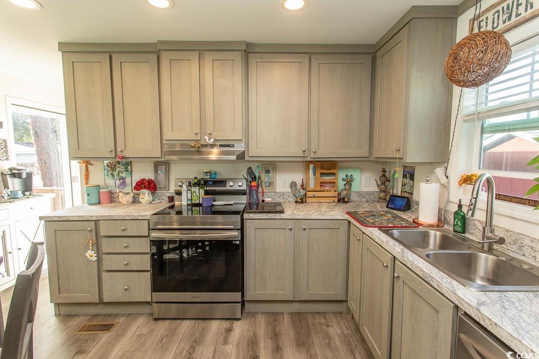 2737 Capricorn Drive Myrtle Beach, SC 29575 - Photo 11 of 27 Kitchen featuring electric range, light countertops, under cabinet range hood, light wood finished floors, and recessed lighting