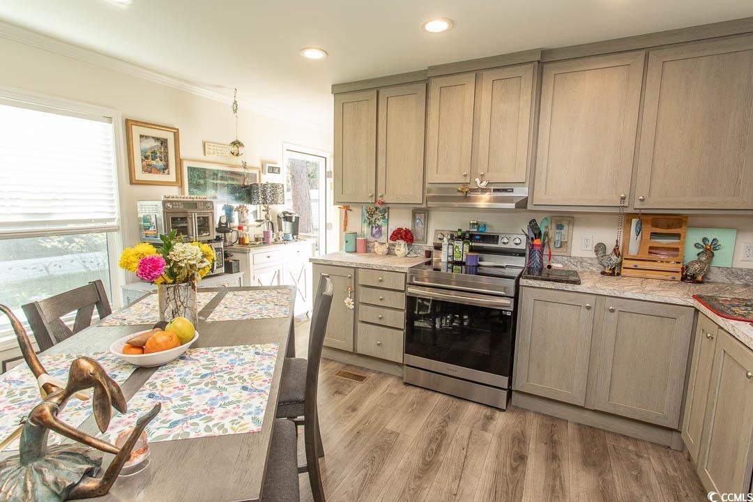 2737 Capricorn Drive Myrtle Beach, SC 29575 - Photo 12 of 27 Kitchen featuring electric range, light wood finished floors, under cabinet range hood, recessed lighting, and crown molding