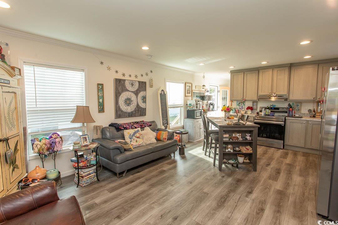2737 Capricorn Drive Myrtle Beach, SC 29575 - Photo 14 of 27 Living area with recessed lighting, ornamental molding, and light wood-style flooring
