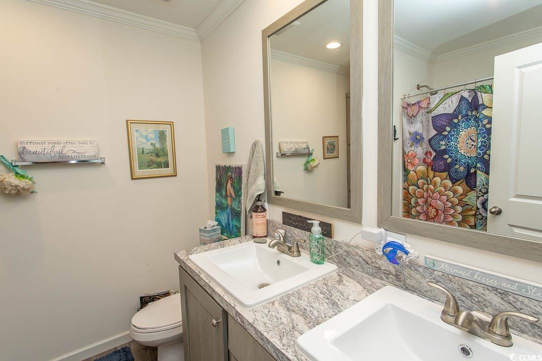2737 Capricorn Drive Myrtle Beach, SC 29575 - Photo 15 of 27 Full bathroom with double vanity, crown molding, and a shower with curtain