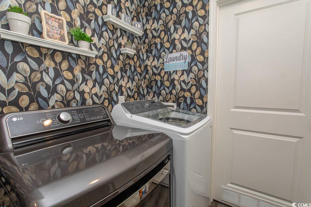 2737 Capricorn Drive Myrtle Beach, SC 29575 - Photo 17 of 27 Laundry area with wallpapered walls and independent washer and dryer