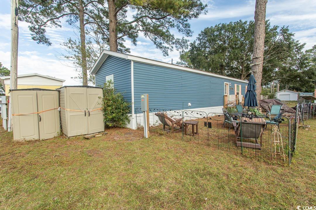 2737 Capricorn Drive Myrtle Beach, SC 29575 - Photo 7 of 27 Rear view of property featuring a storage unit