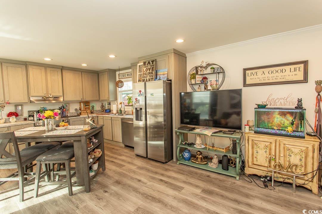 2737 Capricorn Drive Myrtle Beach, SC 29575 - Photo 9 of 27 Kitchen featuring appliances with stainless steel finishes, light wood-style floors, recessed lighting, crown molding, and ventilation hood
