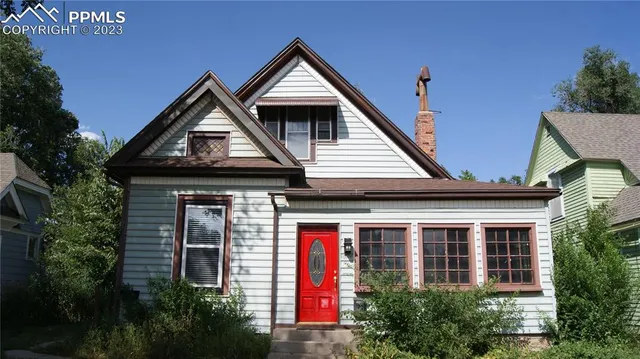a front view of a house with plants