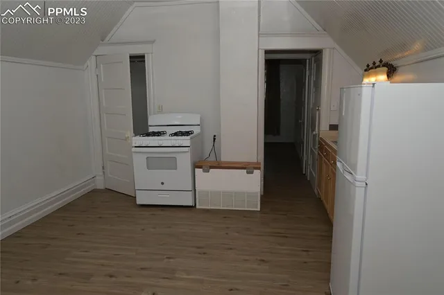 a kitchen with a stove and a refrigerator