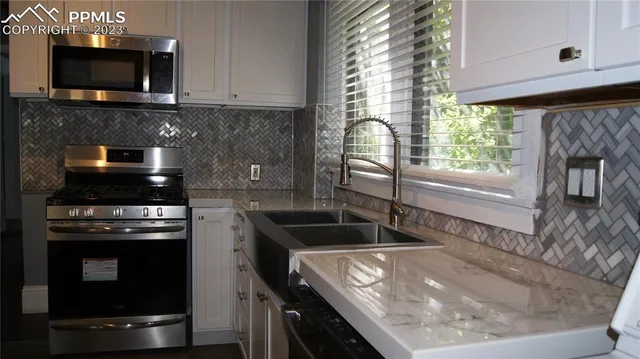 a kitchen with a sink and a stove