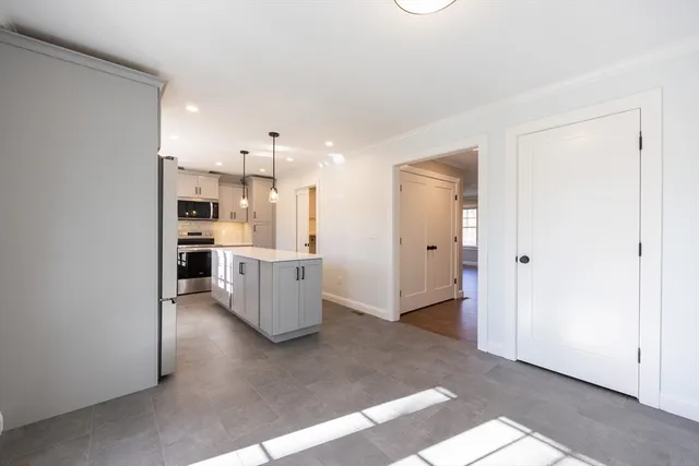 a view of kitchen and refrigerator