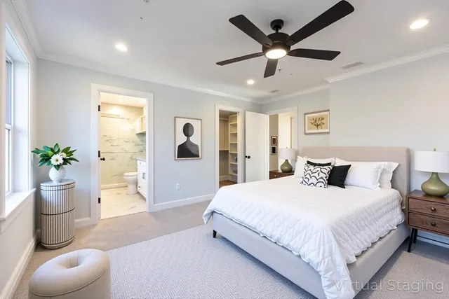 a bedroom with a large bed and ceiling fan