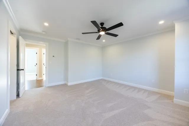 a view of an empty room and a ceiling fan