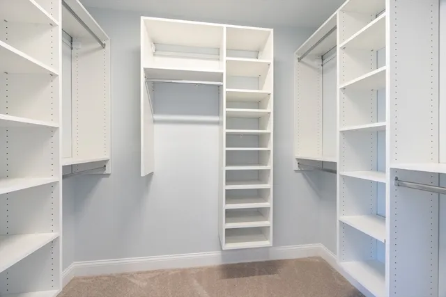 a view of walk in closet with empty racks