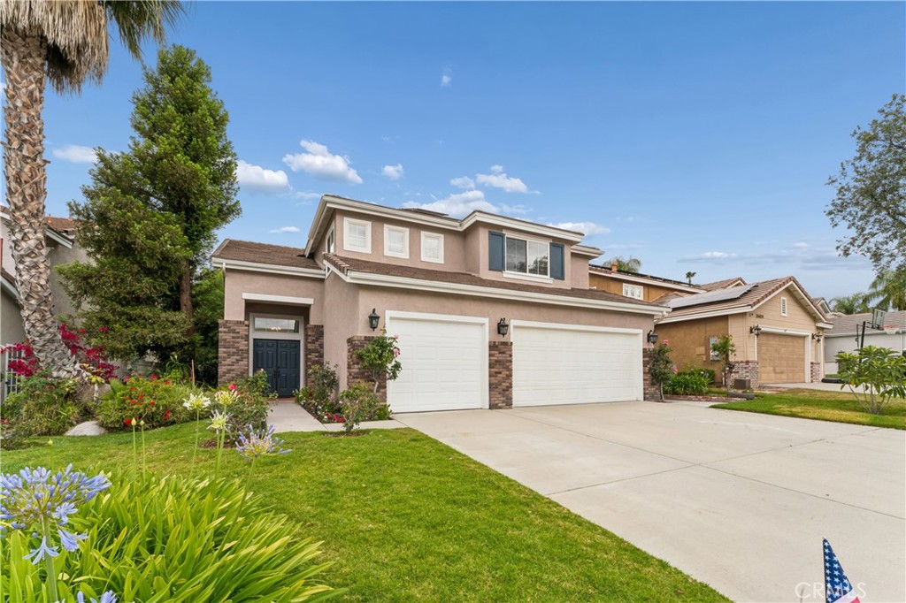 26023 Salinger Lane Stevenson Ranch, CA 91381 - Photo 2 of 35 Front exterior view of the home, showcasing the curb appeal, landscaping, and entryway.