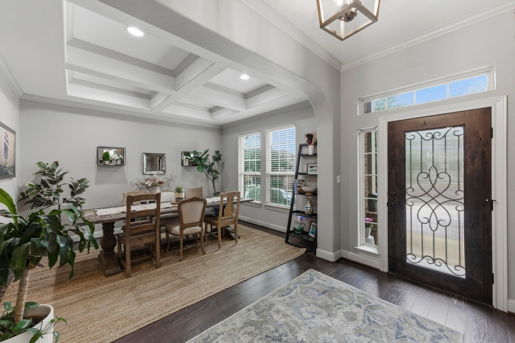 5425 Cherokee Draw Road Austin, TX 78738 - Photo 15 of 40 Step into a luminous dining room with coffered ceilings and rich hardwood flooring, perfect for entertaining.