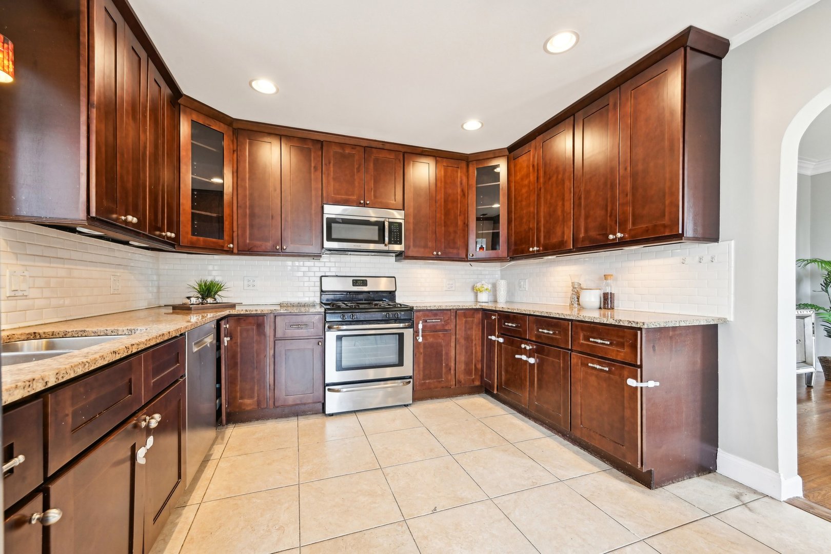 1420 Oakton Street Park Ridge, IL 60068 - Photo 14 of 62 a kitchen with stainless steel appliances granite countertop wooden cabinets a stove top oven a sink and dishwasher