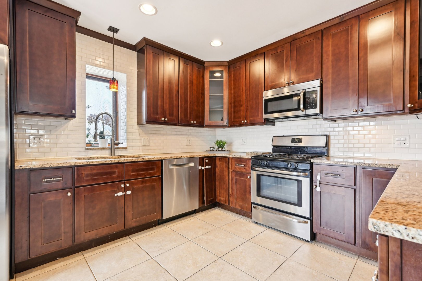 1420 Oakton Street Park Ridge, IL 60068 - Photo 15 of 62 a kitchen with stainless steel appliances granite countertop wooden cabinets a stove top oven a sink and dishwasher