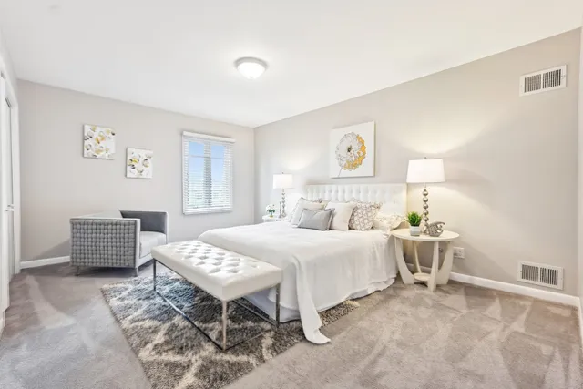 a bed sitting in a bedroom next to a window