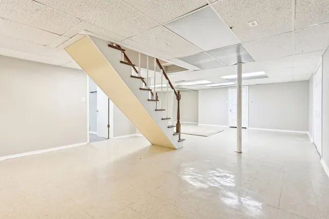 a view of a white house with a yard and potted plants