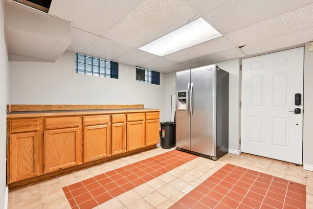 a front view of a house with a yard and potted plants