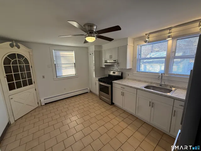 a kitchen with a sink cabinets and window