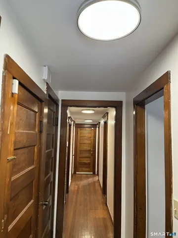 a view of a hallway with a wooden cabinets