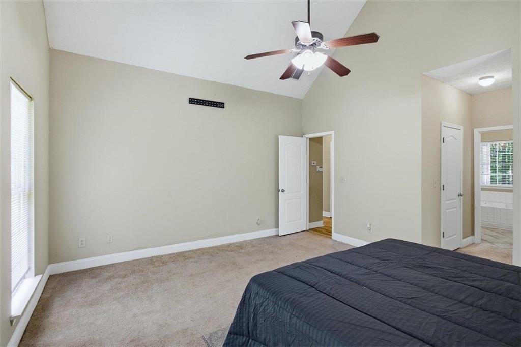 1231 Hillview Road Hampton, GA 30228 - Photo 17 of 49 a bedroom with a bed and a chandelier
