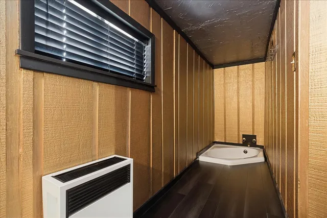 a kitchen with windows and refrigerator