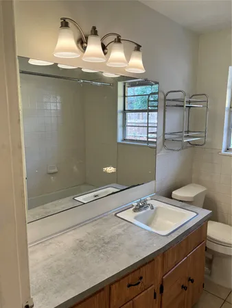 a view of a room with wooden floor and a ceiling fan