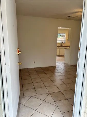 a view of an empty room and a window