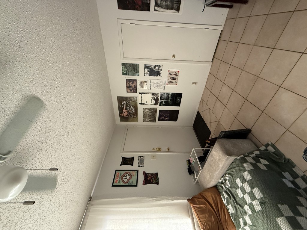 8311 Hathaway Drive, Unit A Austin, TX 78757 - Photo 2 of 6 a bedroom with a bed and a window