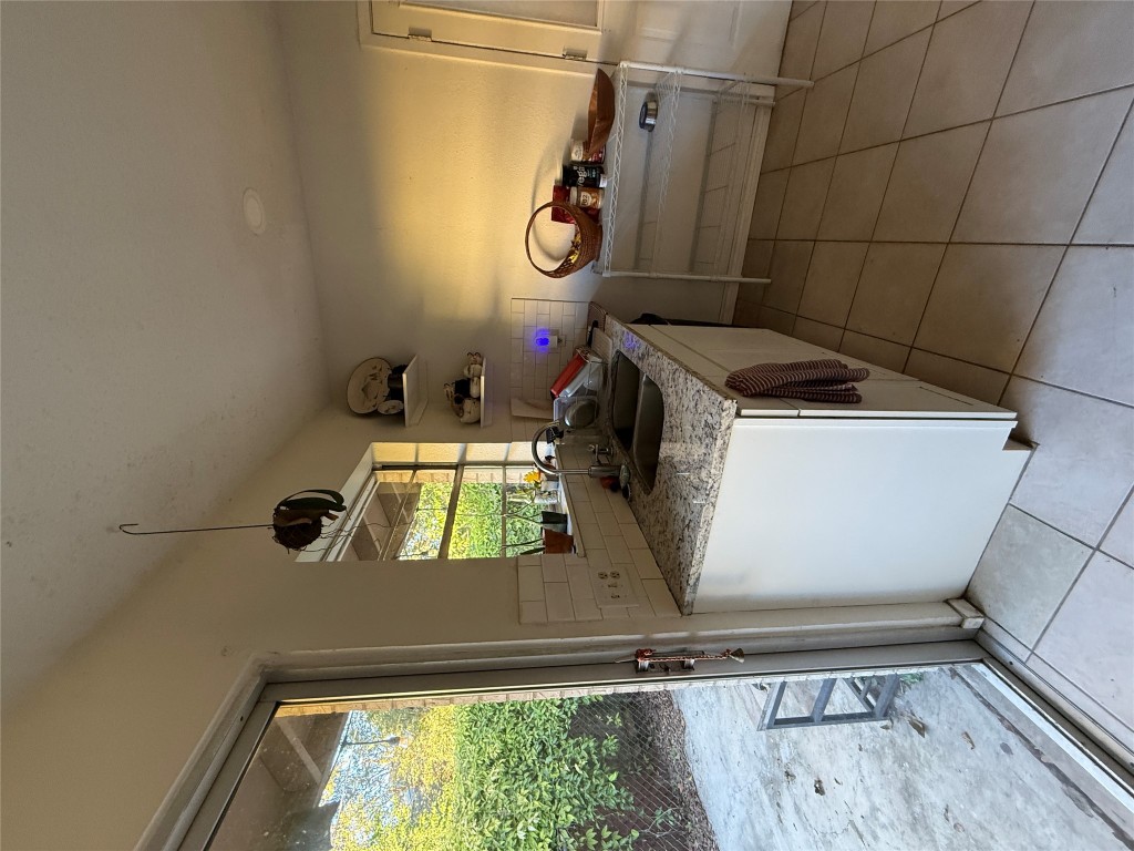 8311 Hathaway Drive, Unit A Austin, TX 78757 - Photo 5 of 6 a kitchen with a stove and a sink