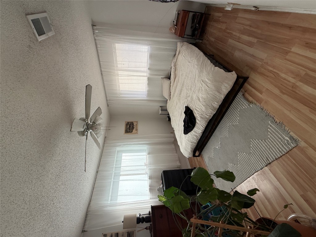 8311 Hathaway Drive, Unit A Austin, TX 78757 - Photo 6 of 6 a spacious bedroom with a bed and a chandelier