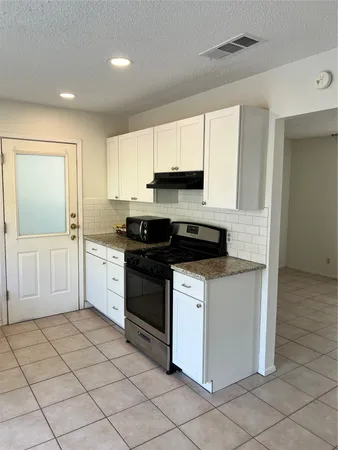 a kitchen with a sink cabinets and appliances