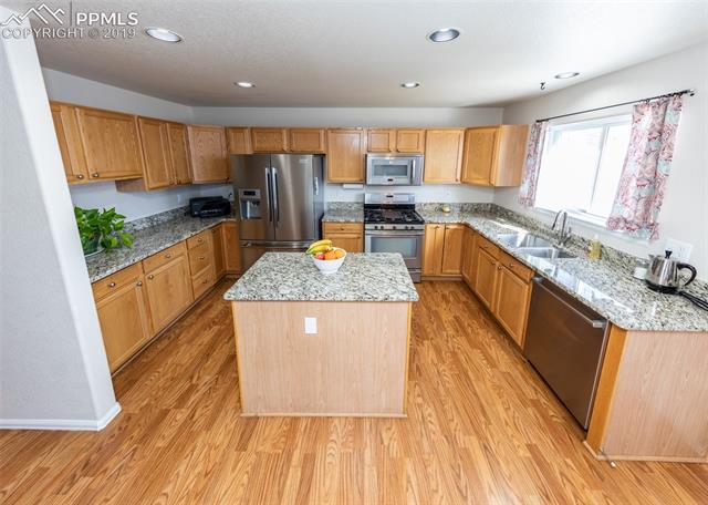 8587 Saddleman Road Peyton, CO 80831 - Photo 7 of 31 Granite counter tops and plenty of storage!