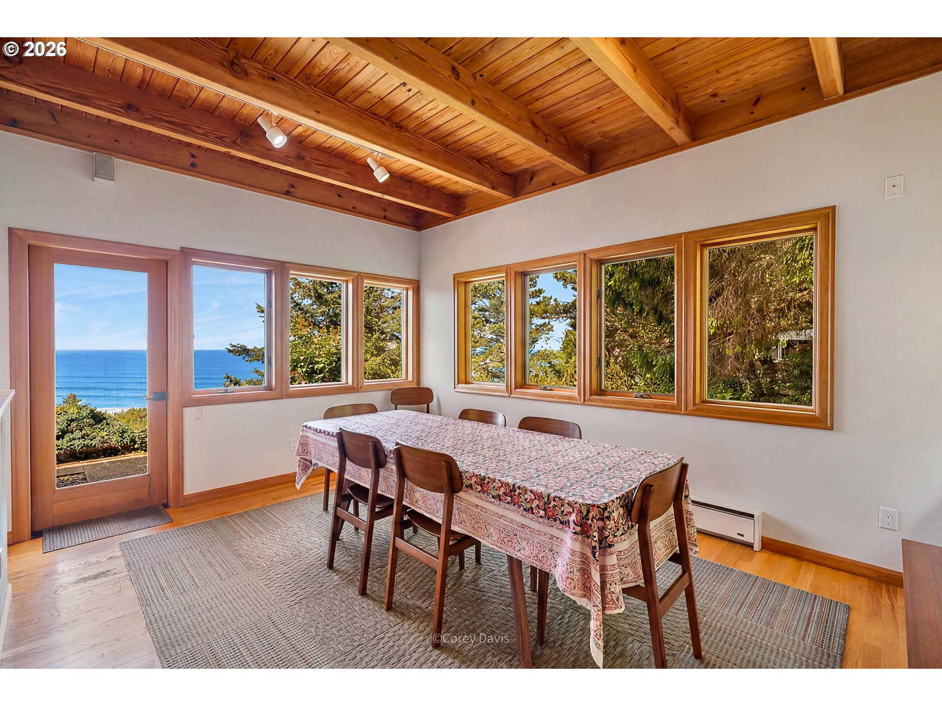 38295 Beulah Reed Road Nehalem, OR 97131 - Photo 16 of 42 a view of a dining room with furniture large windows and wooden floor