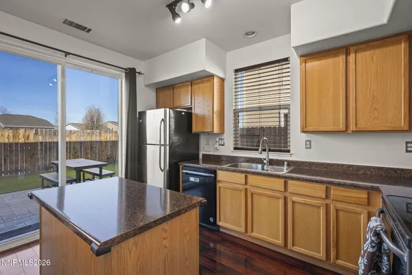 a kitchen with wooden cabinets and refrigerator