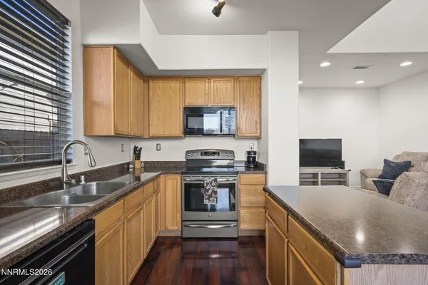 a kitchen with stainless steel appliances granite countertop a stove and a sink